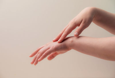 Close-up of woman hand over white background