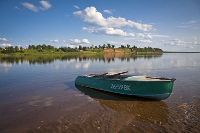 Boat on lake against sky