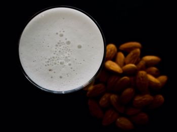 Directly above shot of coffee on table against black background