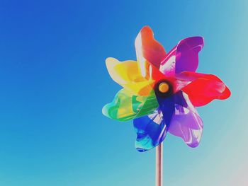 Close-up of pinwheel toy against blue sky