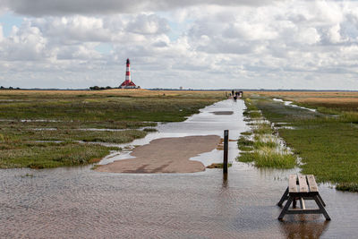 Path to the westerheversand lighthouse at high tide