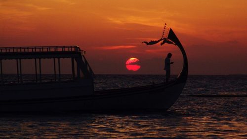 Scenic view of sea against orange sky