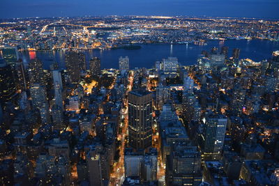 High angle view of city lit up at night