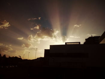 Low angle view of buildings against sky during sunset