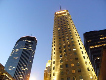 Low angle view of modern buildings against blue sky