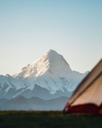 Scenic view of snowcapped mountains against clear sky