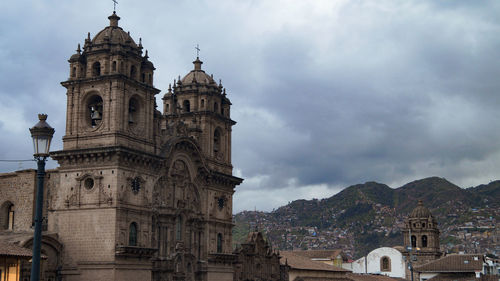 Low angle view of church against cloudy sky