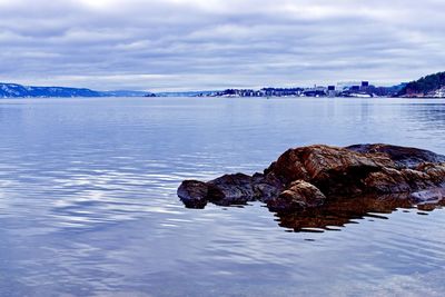 Rocks in sea against sky