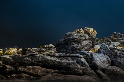 Close-up of rock formation against clear sky at night