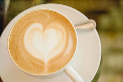 Close-up of cappuccino served on table