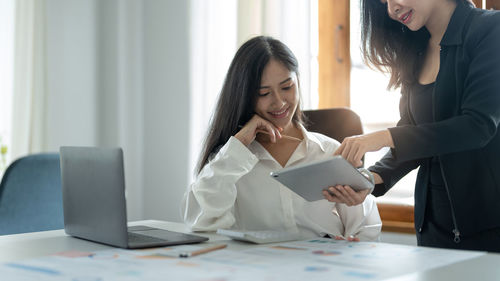 Side view of business colleagues working at office