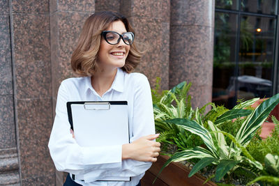 Portrait of a smiling young woman standing outdoors