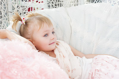 Close-up of girl lying on bed