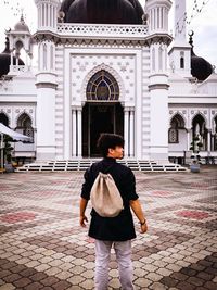 Full length of man standing in temple against sky