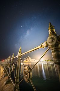 Low angle view of opera house against sky at night