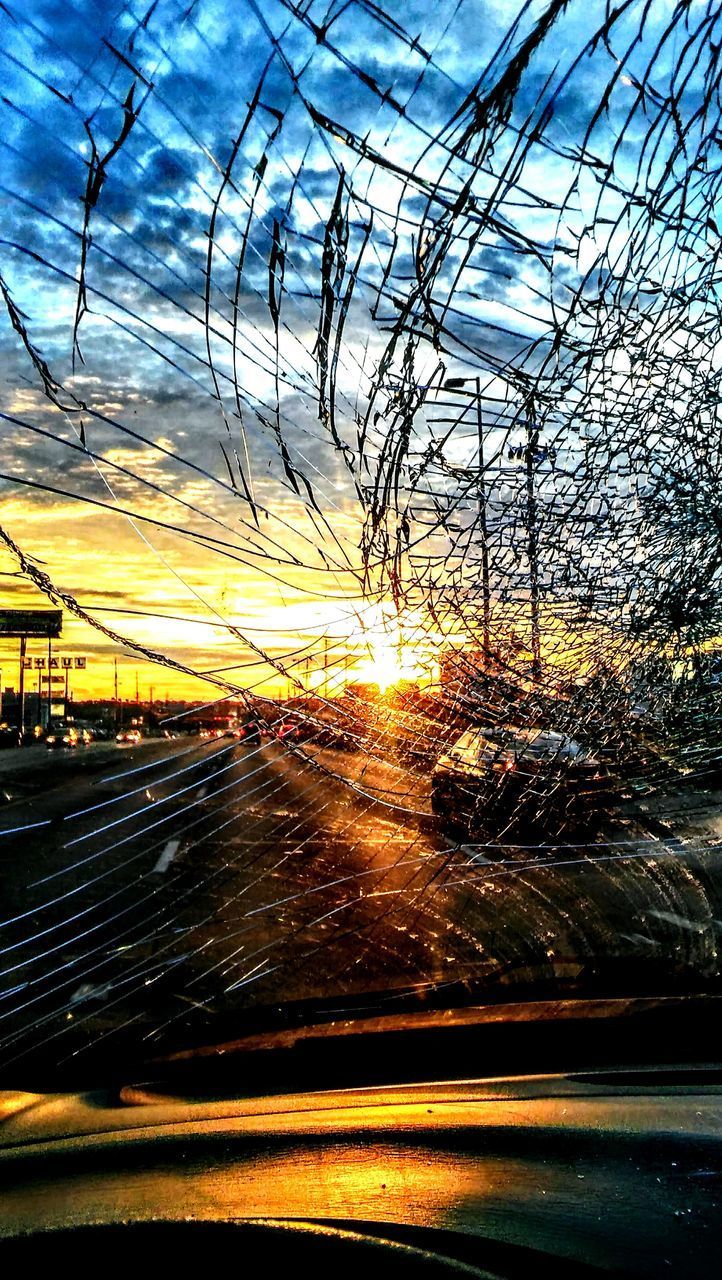 SUNSET SEEN THROUGH CAR WINDSHIELD