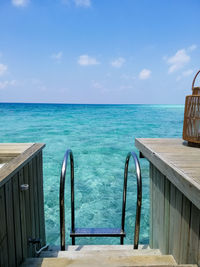 Scenic view of swimming pool by sea against sky