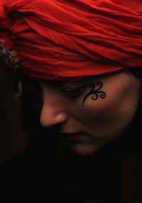 Close-up of young woman wearing red headscarf