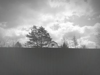 House and trees against sky