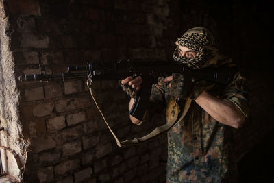 Arab soldier aiming with kalashnikov ak-47 assault rifle.