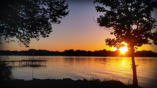 Scenic view of lake against sky during sunset