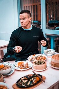 Mid adult man having food in restaurant