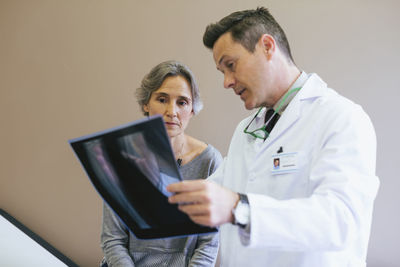 Close-up of doctor explaining x-ray image to patient in medical clinic
