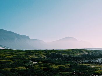 Countryside landscape against mountain range