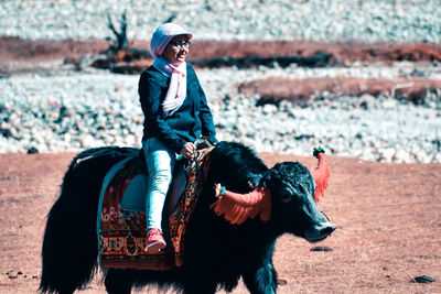 Full length of senior woman riding