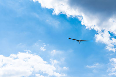 Low angle view of airplane flying in sky