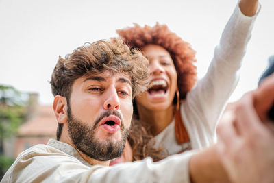 Cheerful couple looking away outdoors