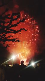 Low angle view of firework display at night