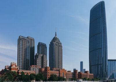 Skyscrapers in city against sky