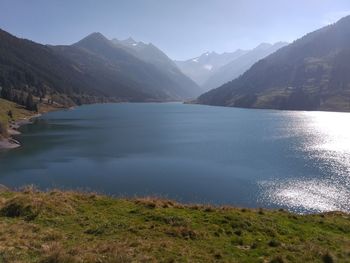 Scenic view of lake and mountains against sky