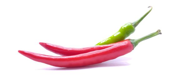 Close-up of red chili pepper against white background