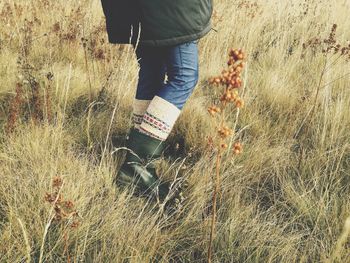 Low section of man standing on field