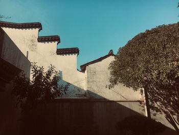 Low angle view of buildings against clear blue sky