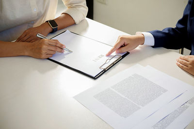 Close-up of business colleagues working in office