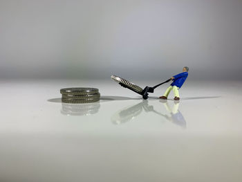 Close-up of toy on table against white background