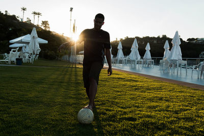 Man playing soccer on field at park