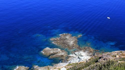 High angle view of rocks on sea shore