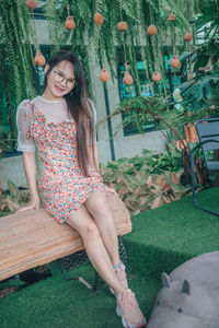 Portrait of smiling young woman sitting outdoors