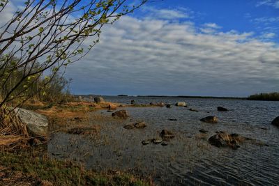 Scenic view of sea against cloudy sky