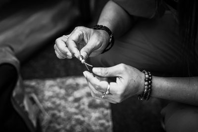 Close-up of woman making bracelet