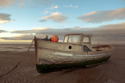 Abandoned boat on shore