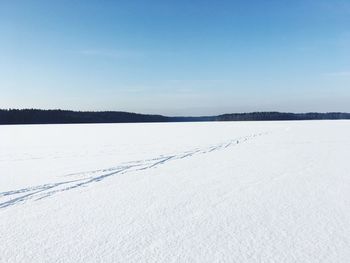 Snow covered landscape against sky