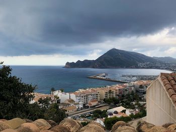 Panoramic view of sea and buildings against sky