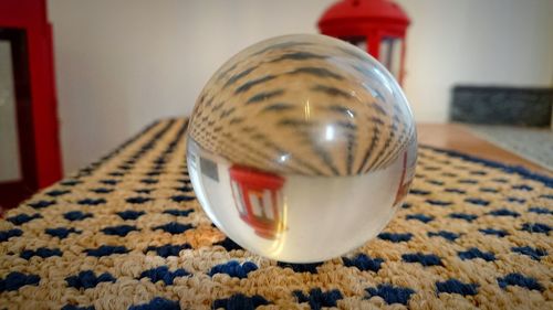 Close-up of crystal ball on table at home