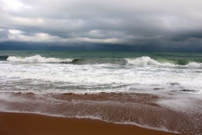 Scenic view of sea against cloudy sky