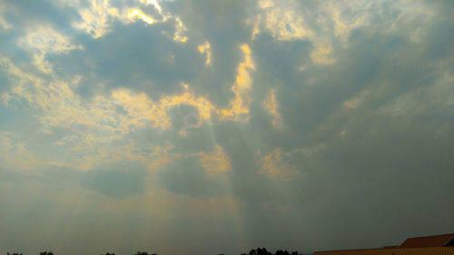 Low angle view of rainbow against sky at sunset